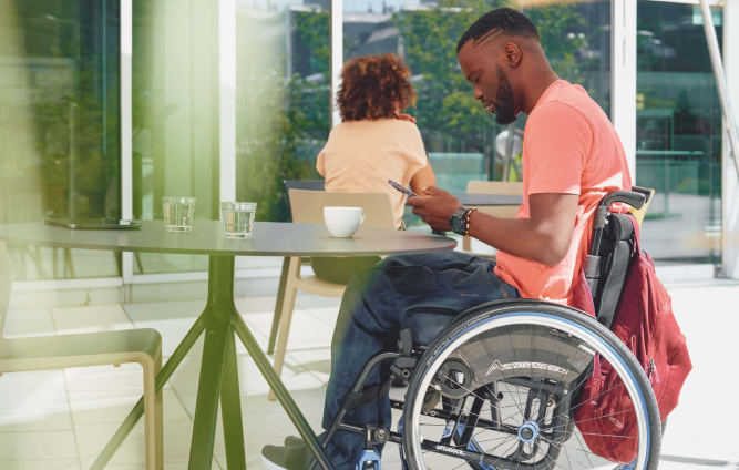 man in a wheelchair using his phone